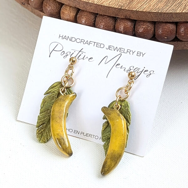 yellow plantain earrings in front of wooden table