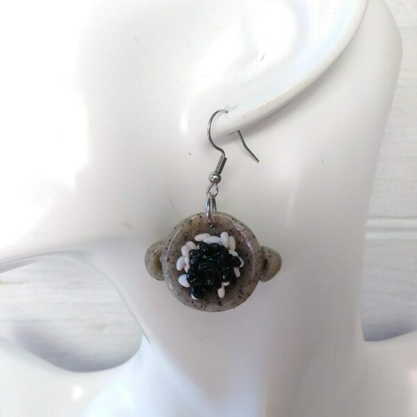 rice and black beans earrings on mannequin