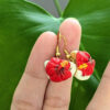 hibiscus coffee earrings on fingers