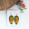 puerto rico pasteles earrings next to leaves and flowers