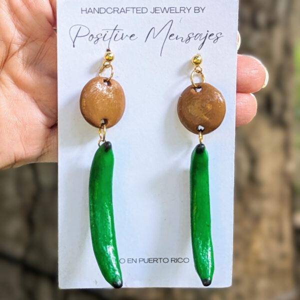 plantain art earrings in front of tree