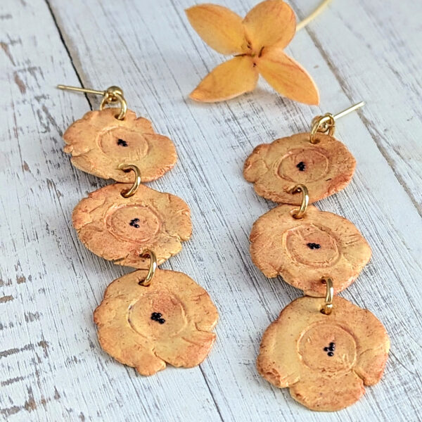 long tostones earrings on white wood