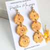 side view of long tostones earrings