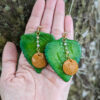 taino oregano jewelry in front of tree