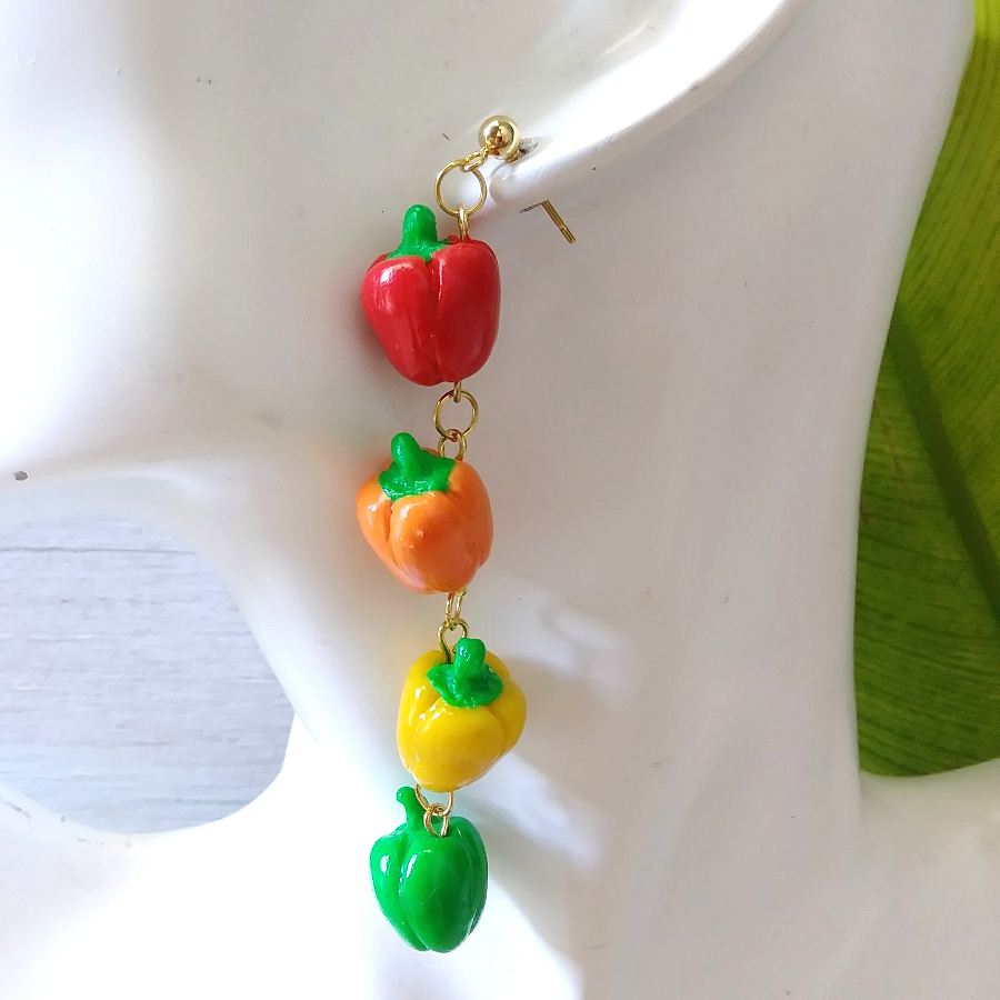bell pepper art earrings on ear