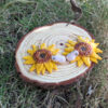 sunflower coqui earrings on log