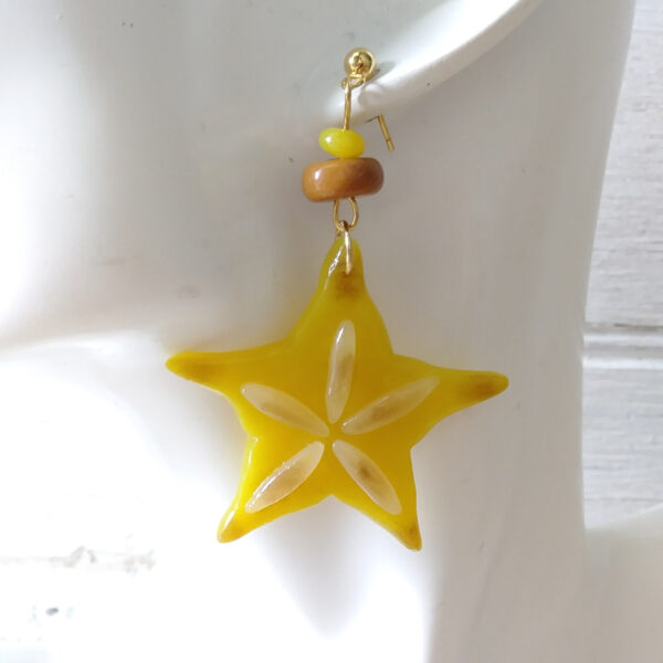star fruit earrings on ear