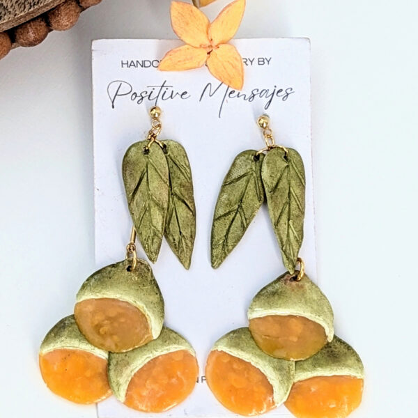 handmade spanish lime earrings with round wood table
