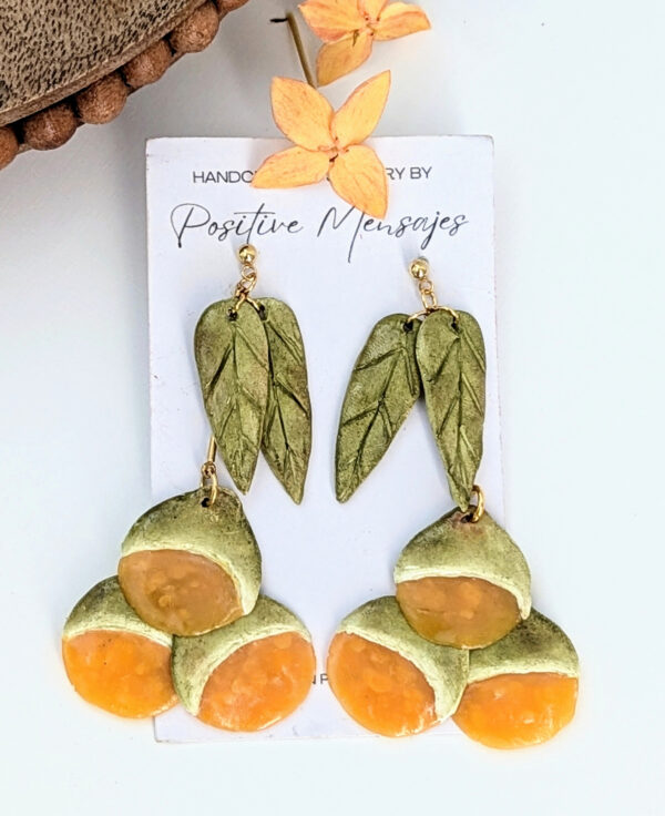 handmade spanish lime earrings with round wood table
