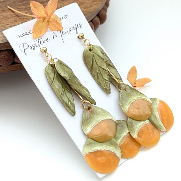 handmade quenepa earrings left view with flower
