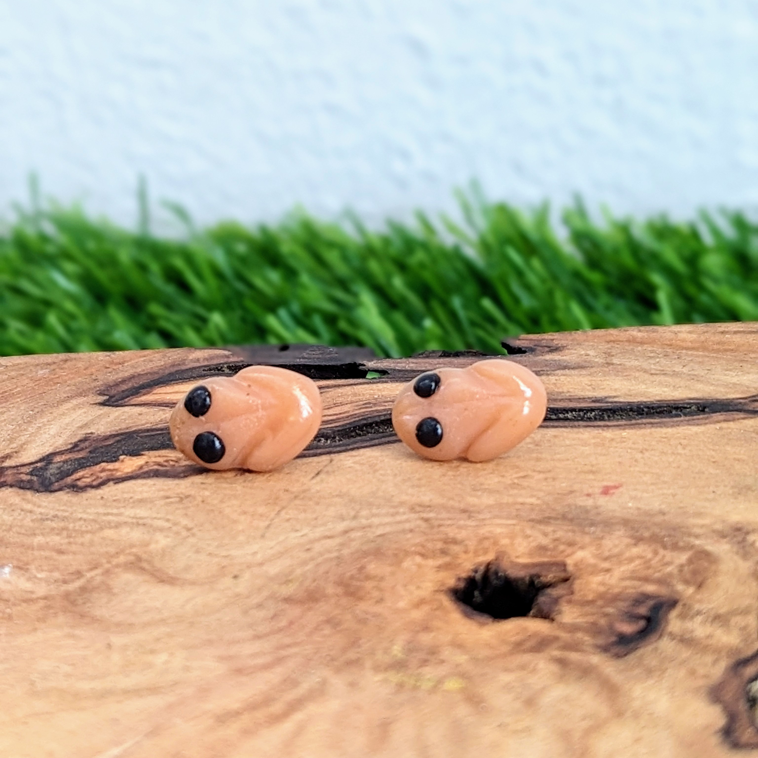 handmade coqui stud earrings looking left