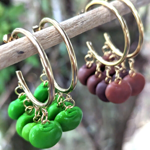 brown green gandules earrings on tree branch