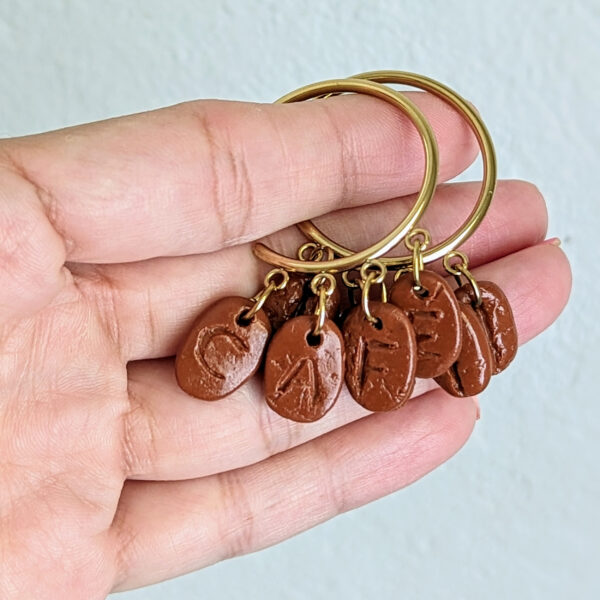 handmade coffee earrings displayed on hand