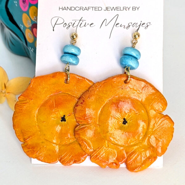 tostones earrings on colorful blue art