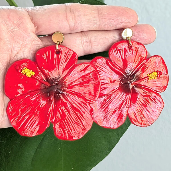 flor de maga earrings on hand