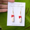 boricua artisan hands with coquito earrings