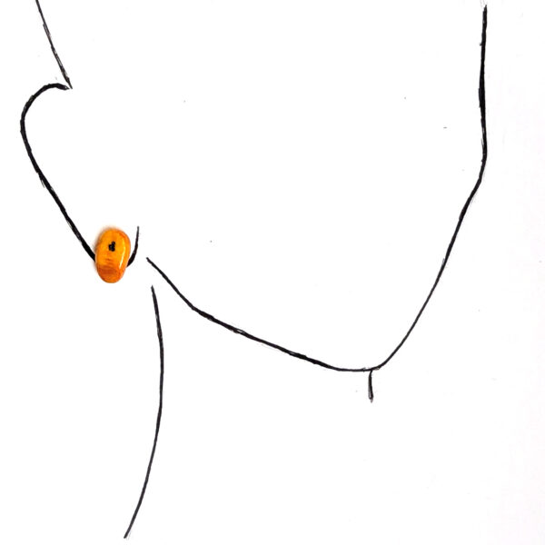 yellow plantain stud earrings on ear