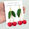 cherry earrings with taino sun symbol on leaves