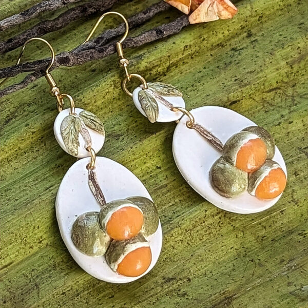 white quenepa fruit earrings side view