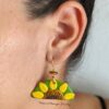 taino sunflower earrings on ear