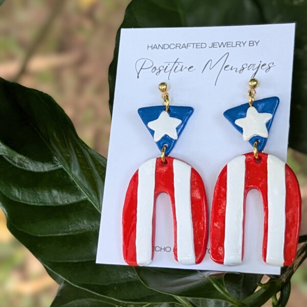 boricua flag earrings on green leaves