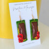 pasteles earrings side view on yellow vase