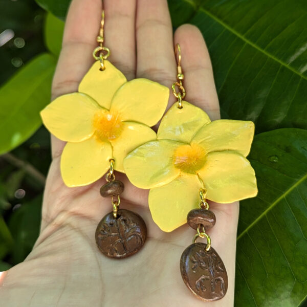 taino yellow flower earrings on hand