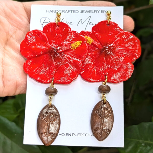 handmade taino earrings in front of leaves