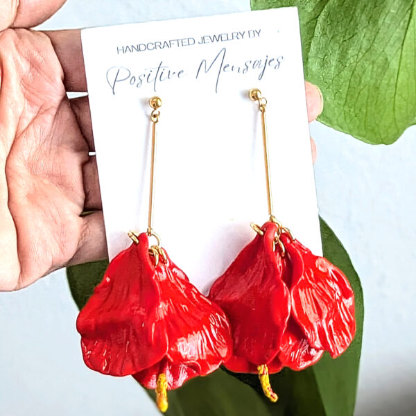 Flor de maga long flowy earrings in front of leaves