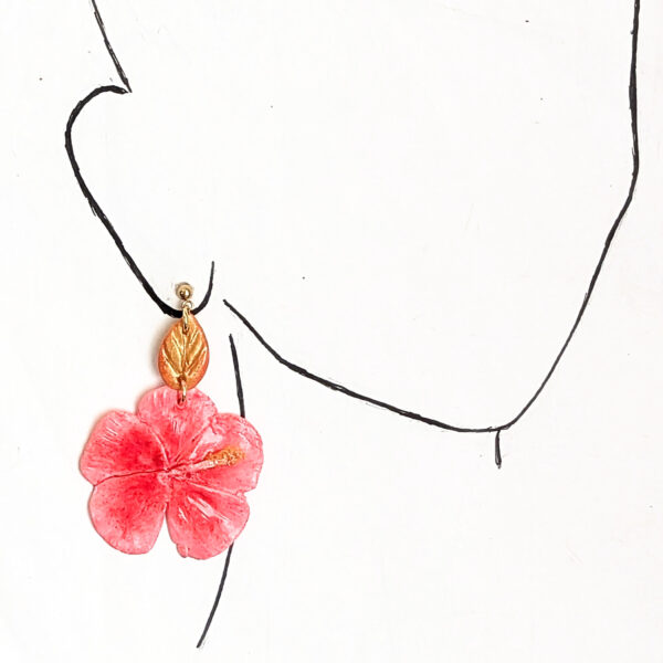 pink Flor de Maga earring on ear