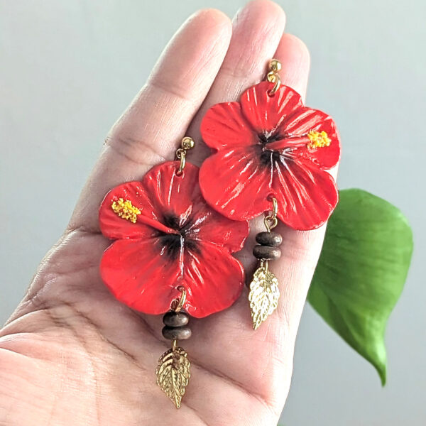 artist holding her flor de maga earrings