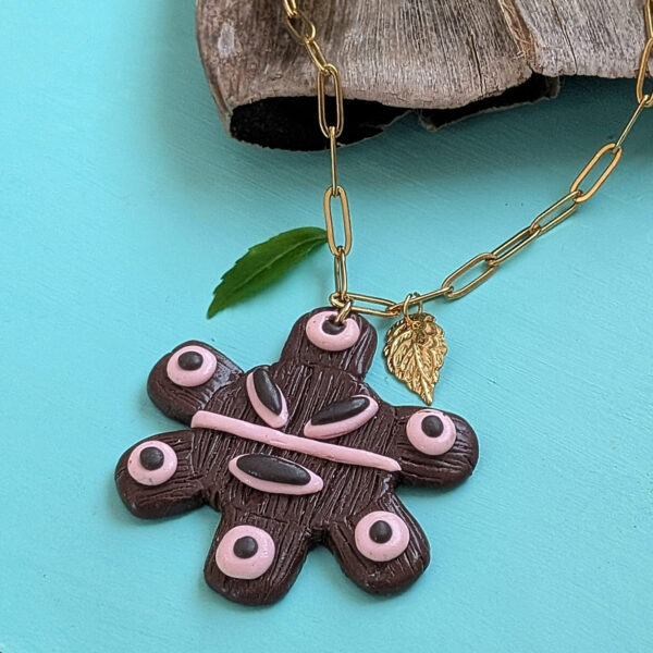 taino necklace with small green leaf